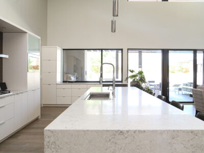 White Countertop Waterfall Edge Island Sink Workstation Pendant Lights White Cabinet Storage Elite Cabinets Tulsa Kitchen